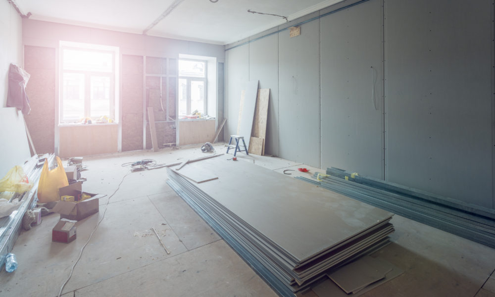 Working process of installing metal frames for plasterboard (drywall) for making gypsum walls  in apartment is under construction, remodeling, renovation, extension, restoration and reconstruction.